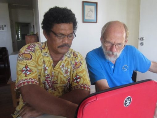 Nico and Chief Nathan Nukusaumua checking the Gospel of Luke 